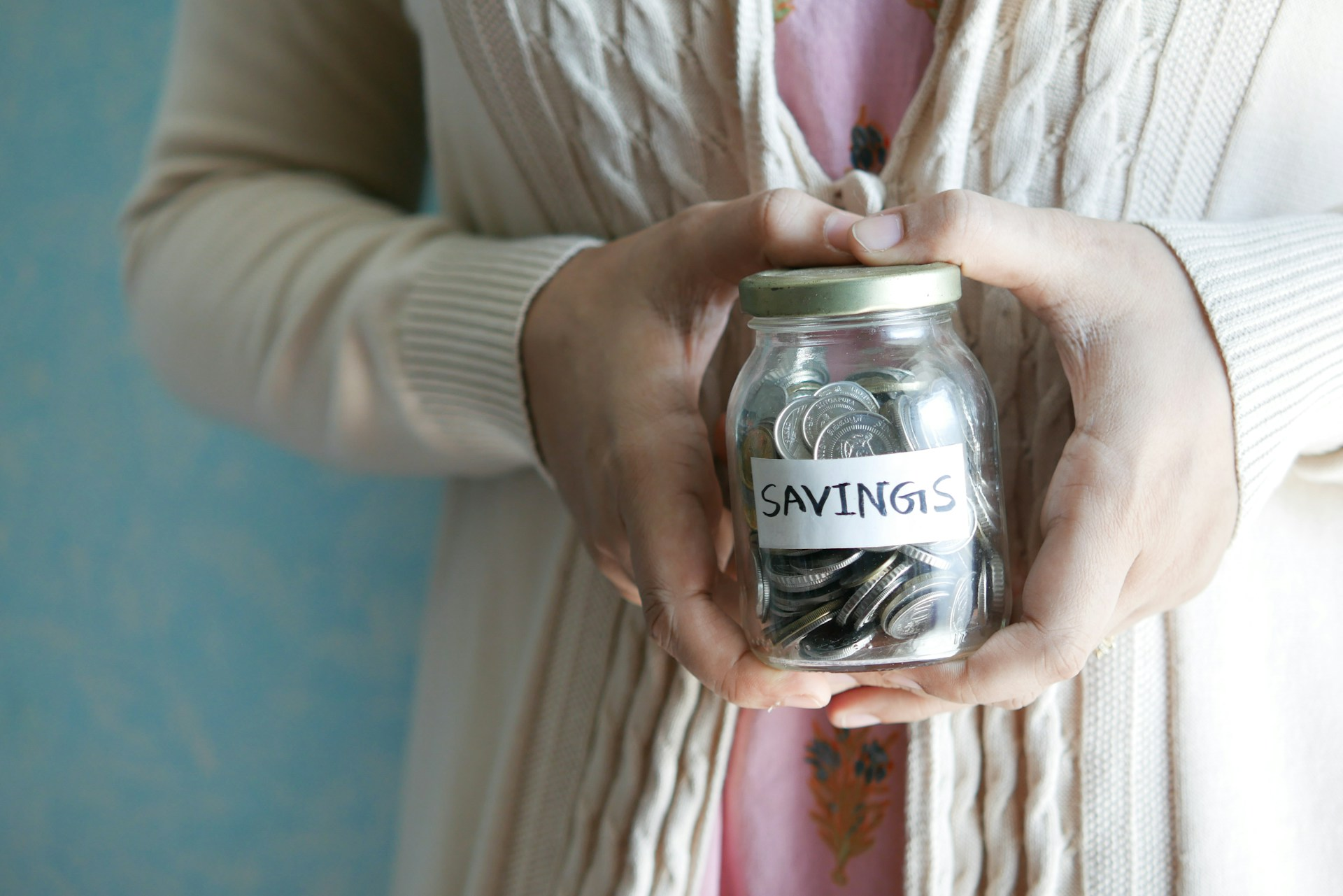 A person holding her savings