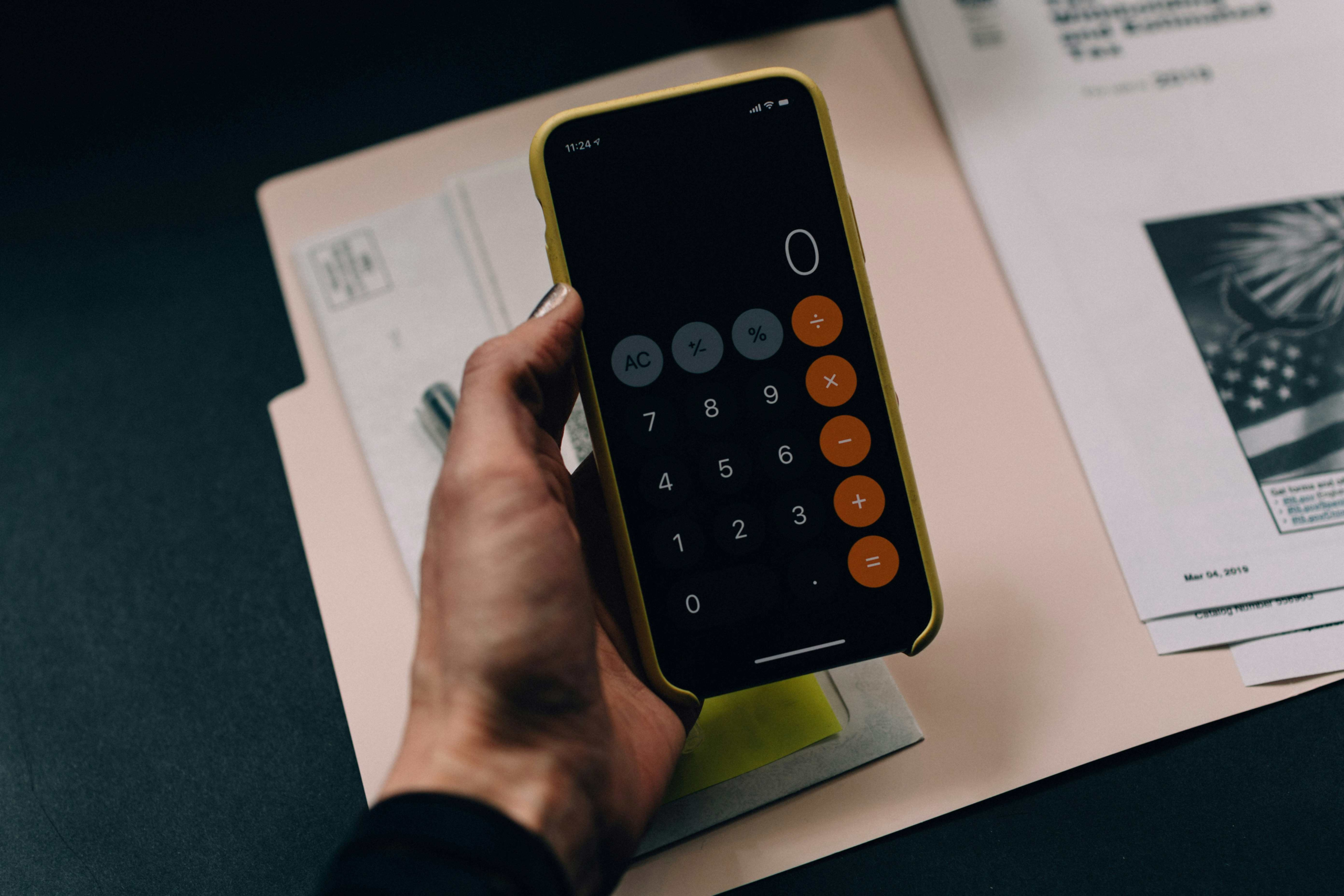 person using calculator app in phone