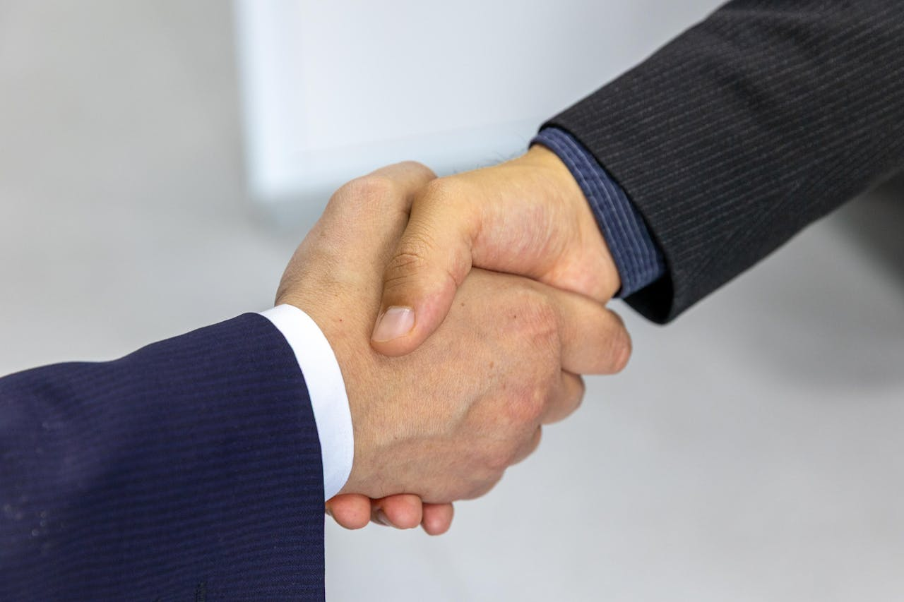 A close up of two people shaking hands