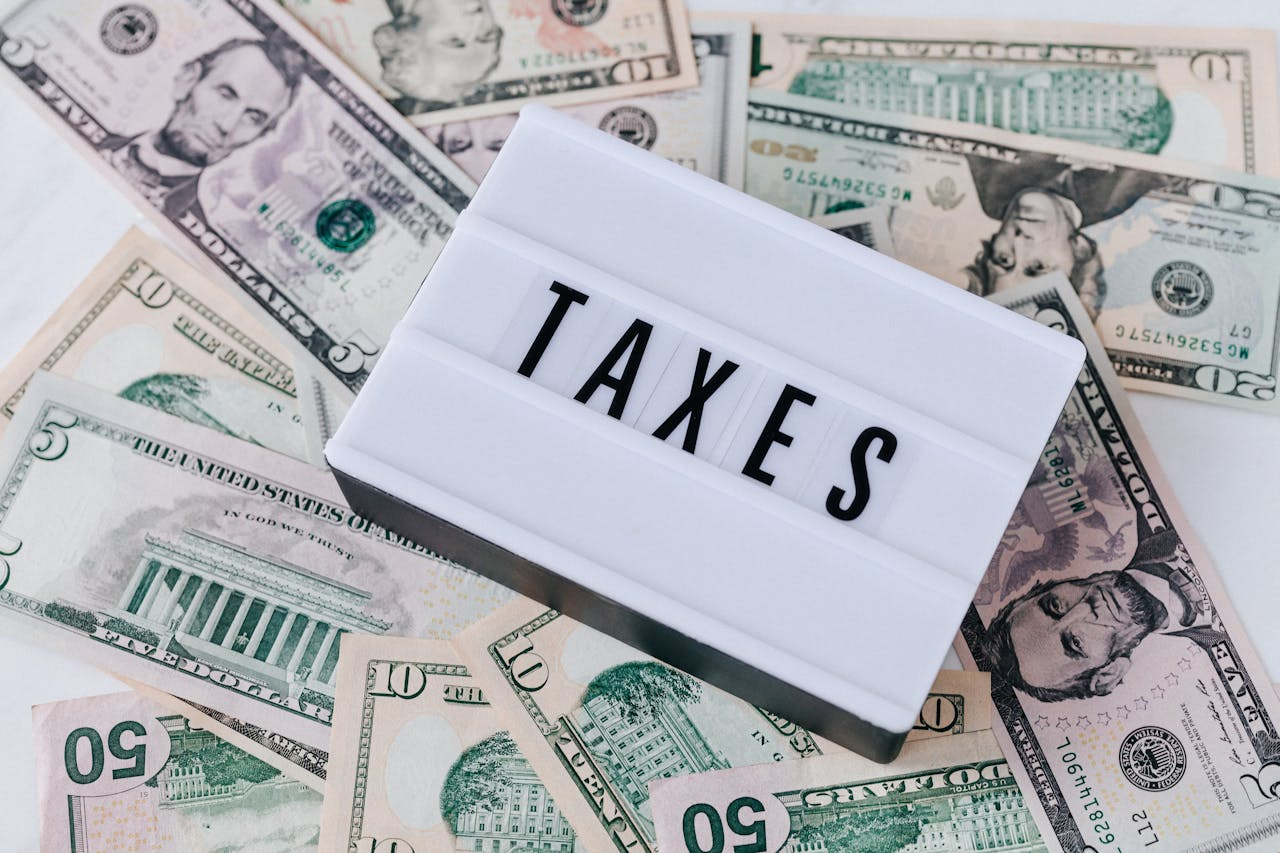 The word taxes with money in the background