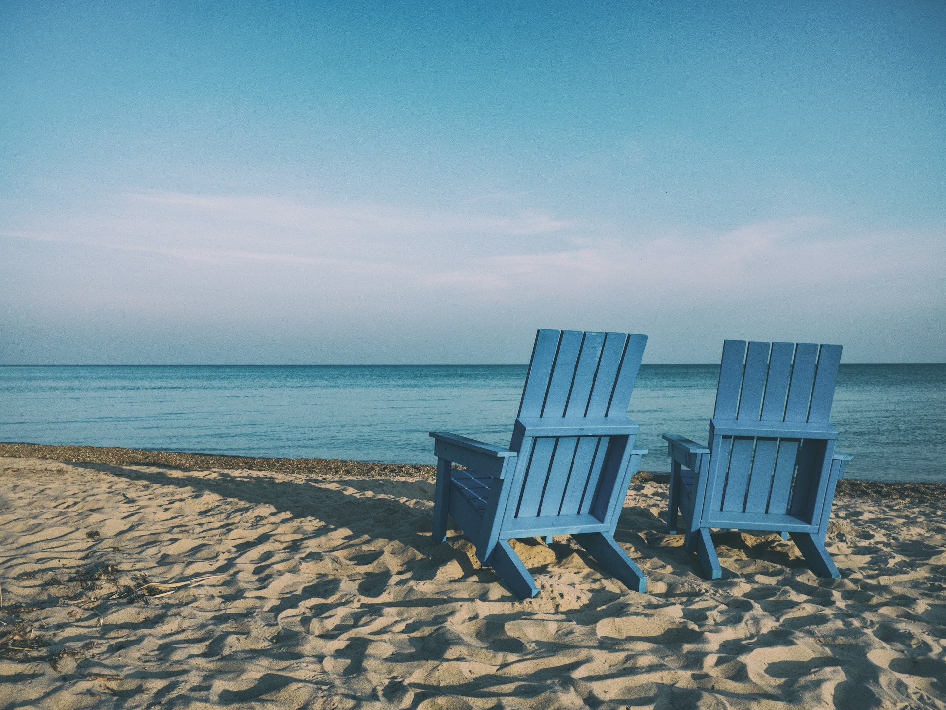 Two empty chairs on a beach