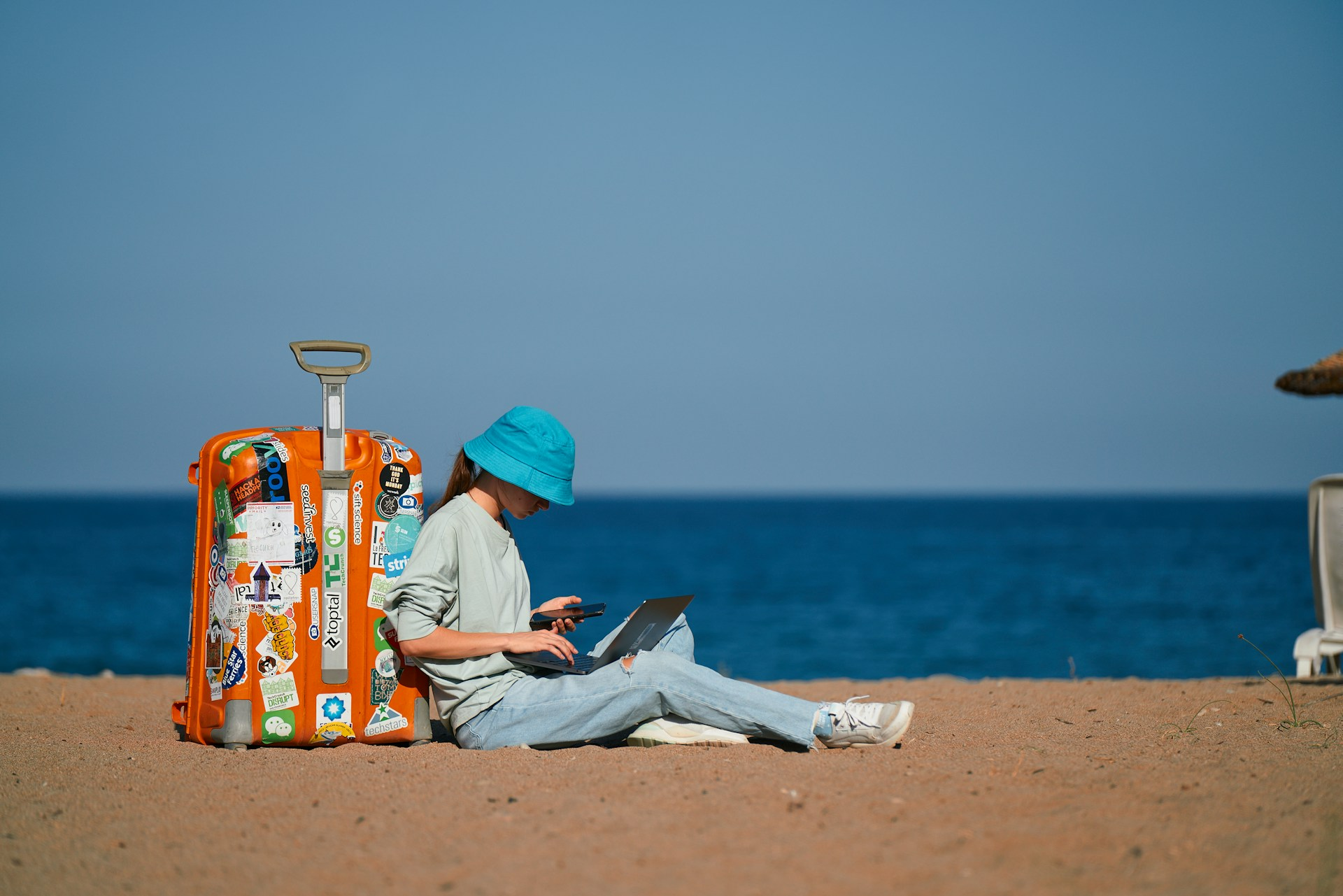 A digital nomad working by the beach