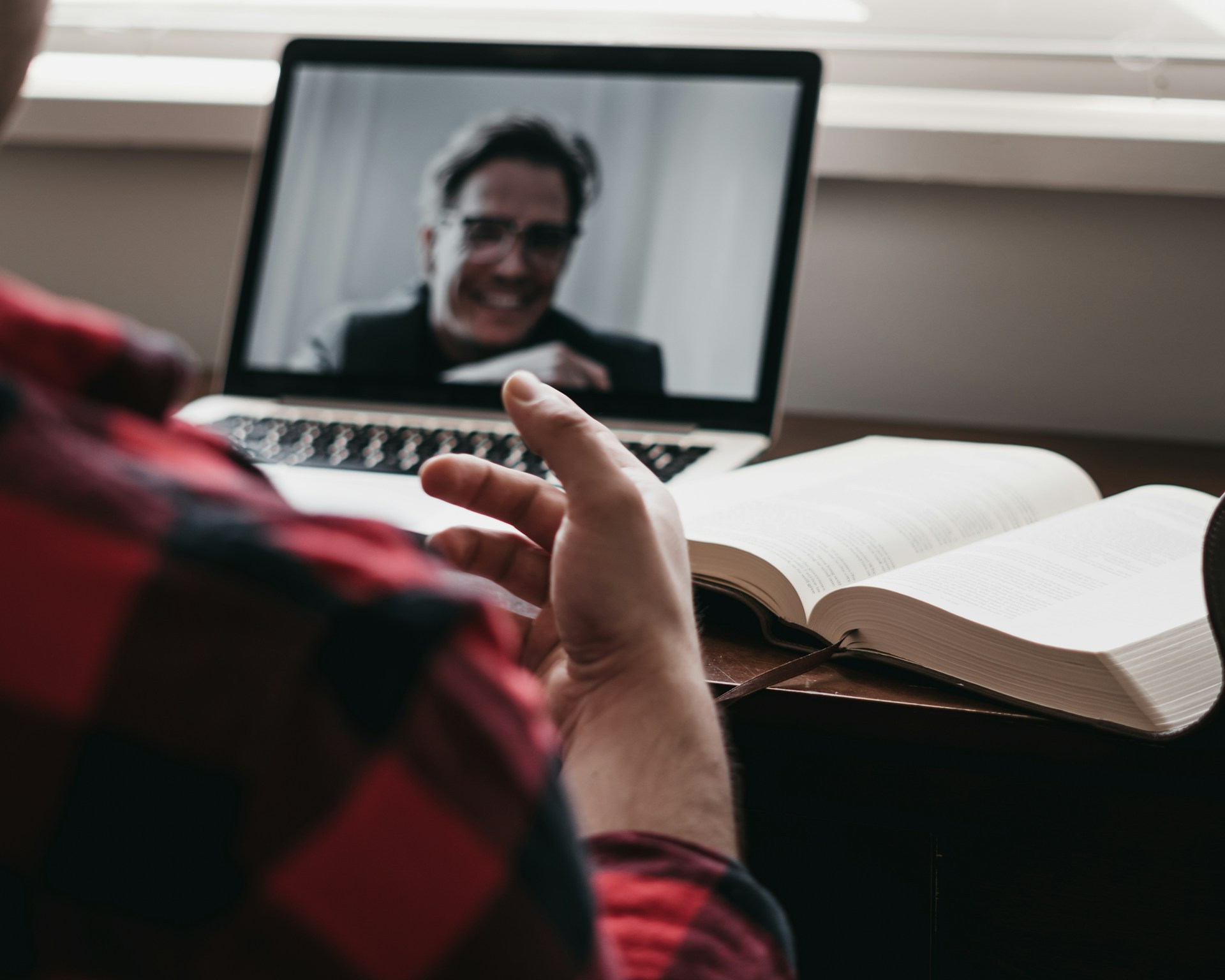 A person talking to someone on his laptop