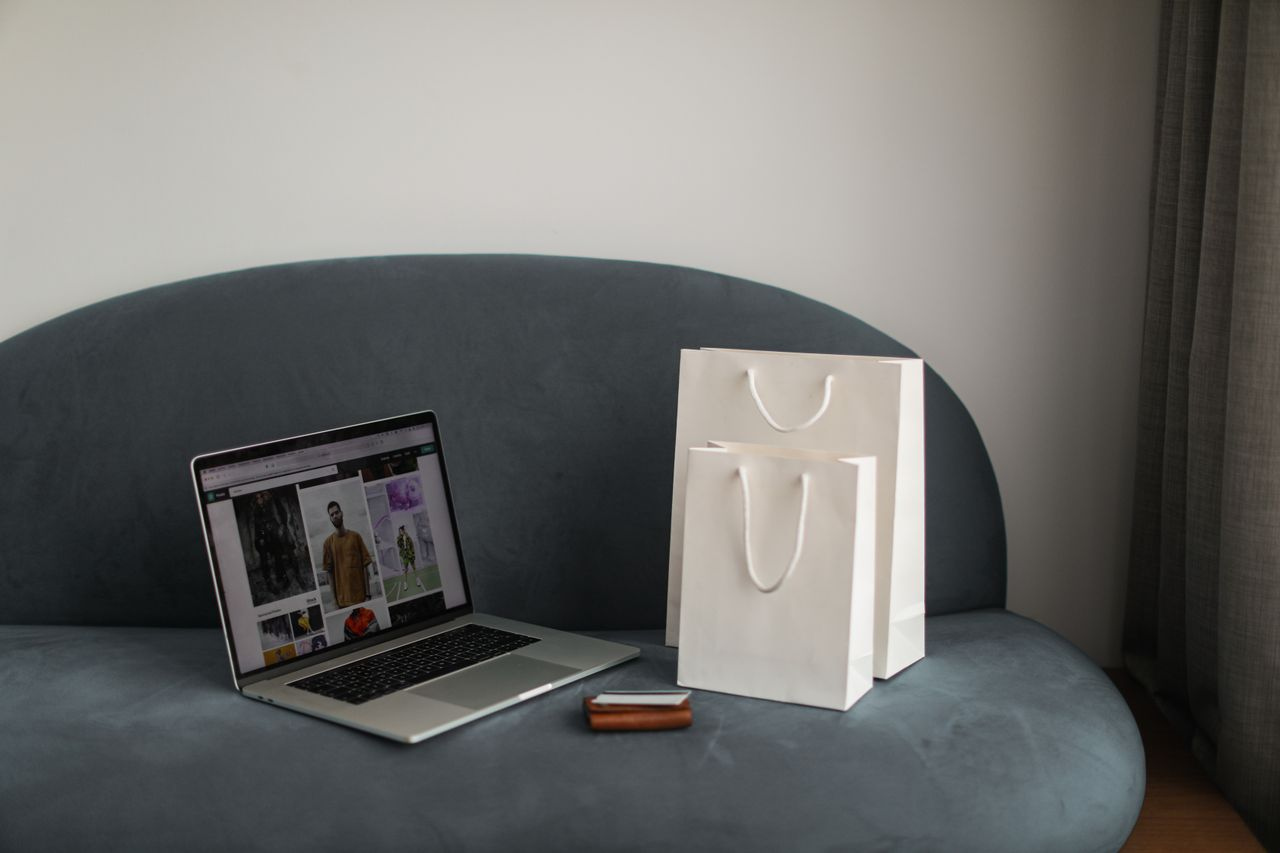 Laptop and shopping bags on a chair