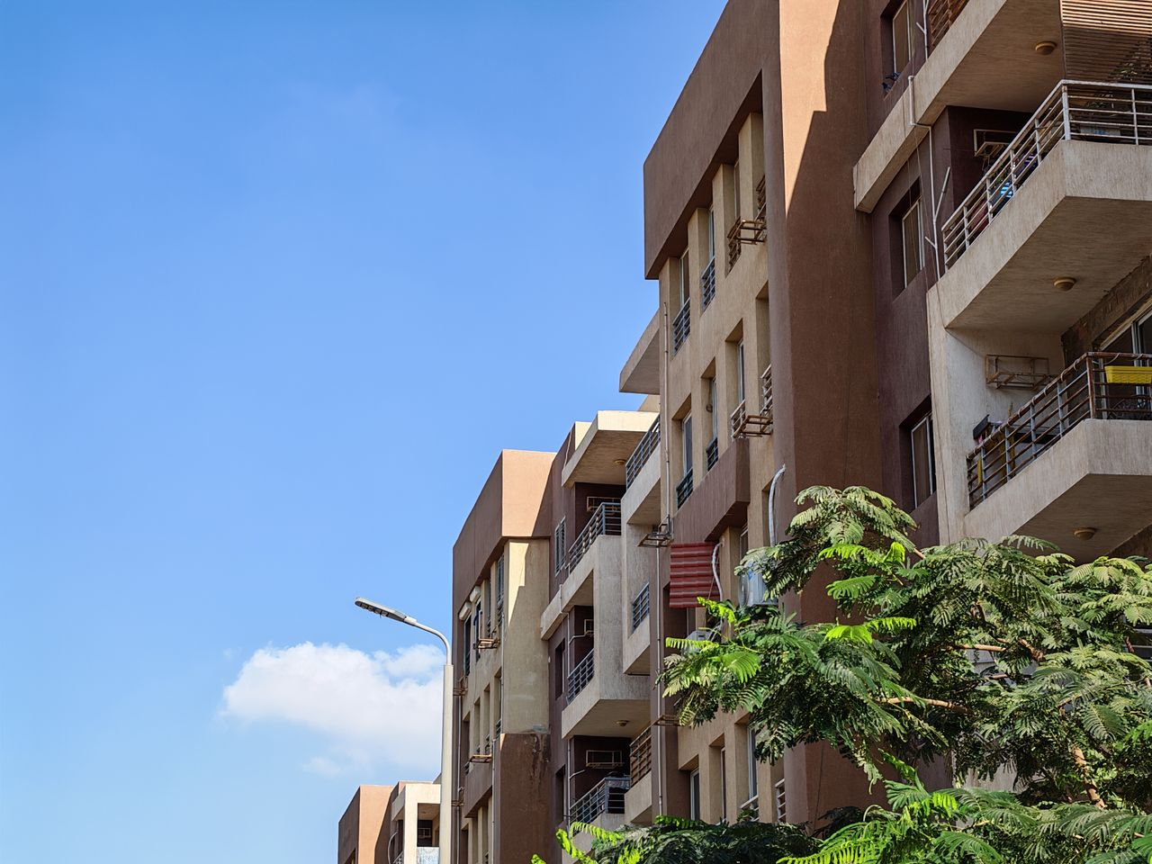 Urban apartment buildings with the blue sky as background