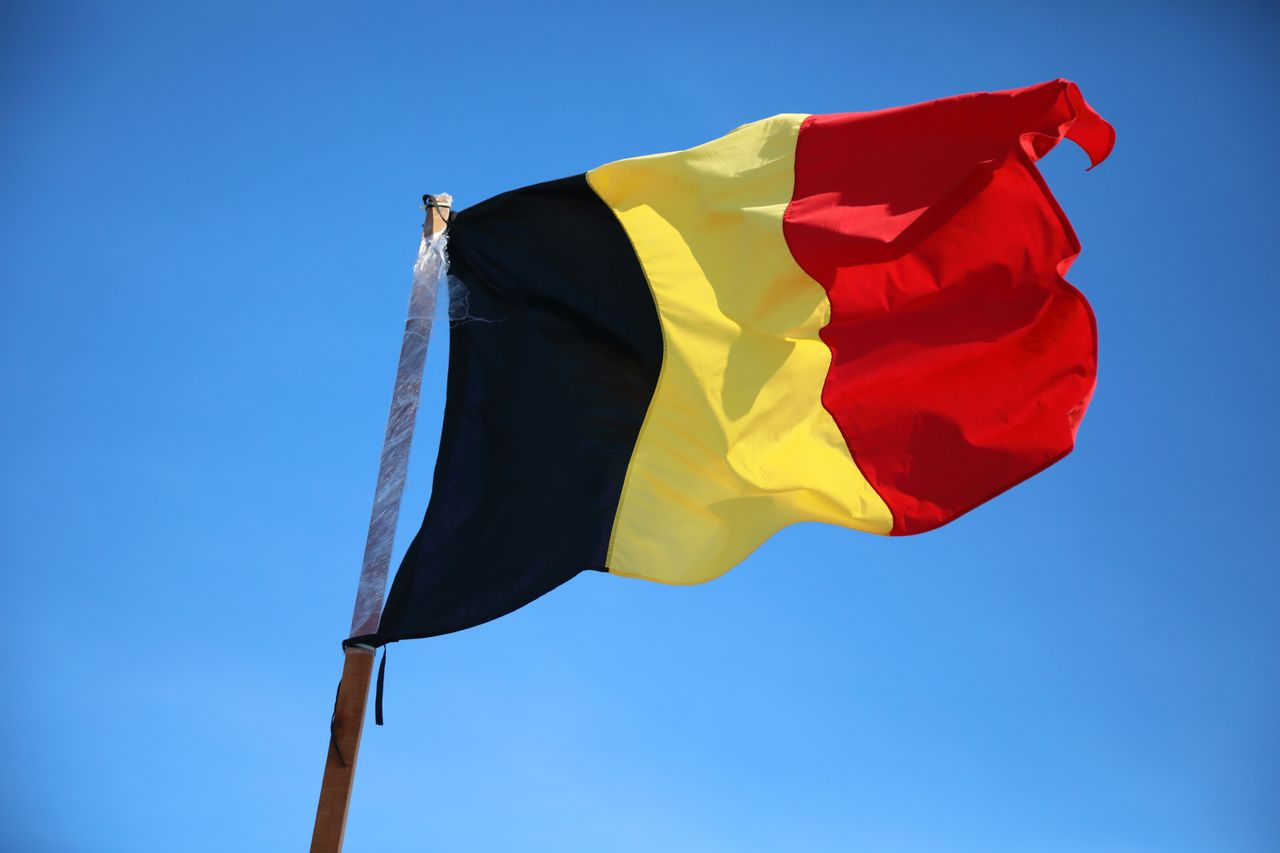 Belgium flag against clear blue sky