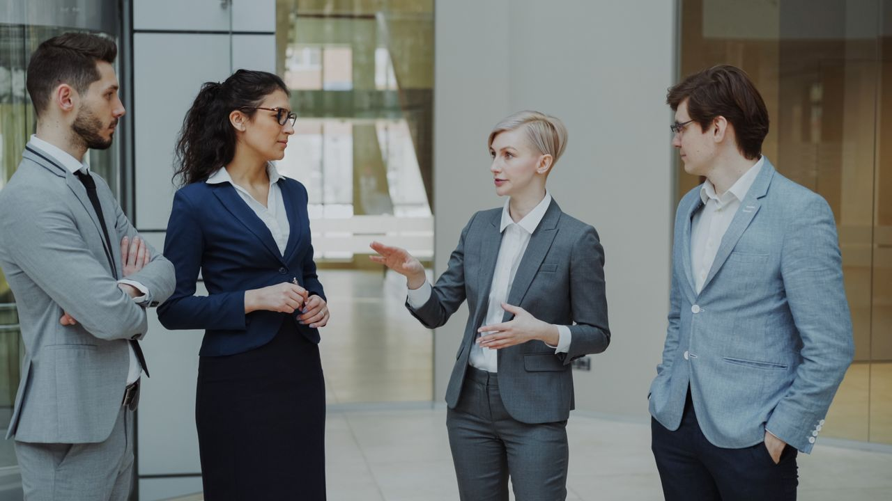 Business professionals in suits discussing work