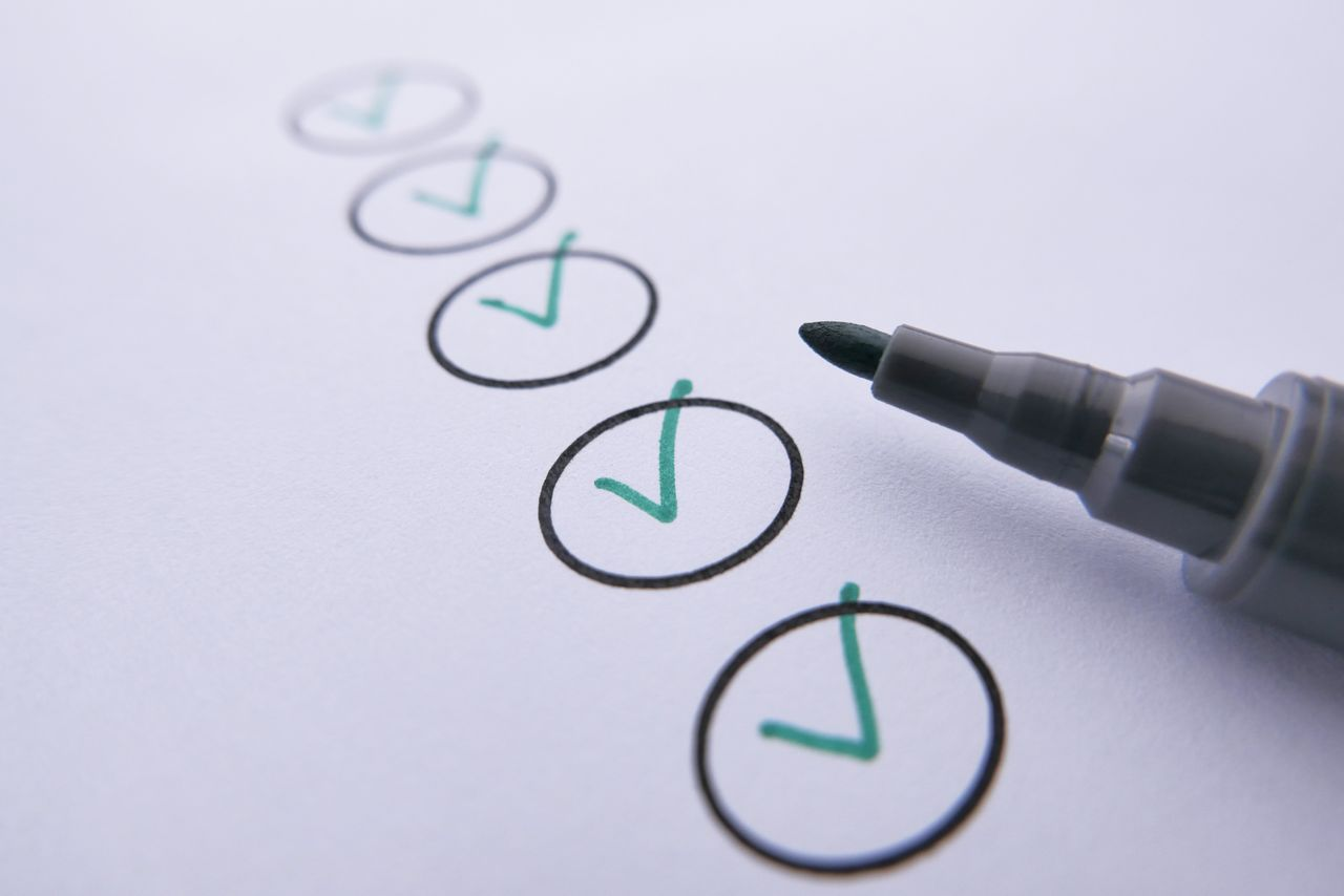 Close-up of a checklist with green checkmarks