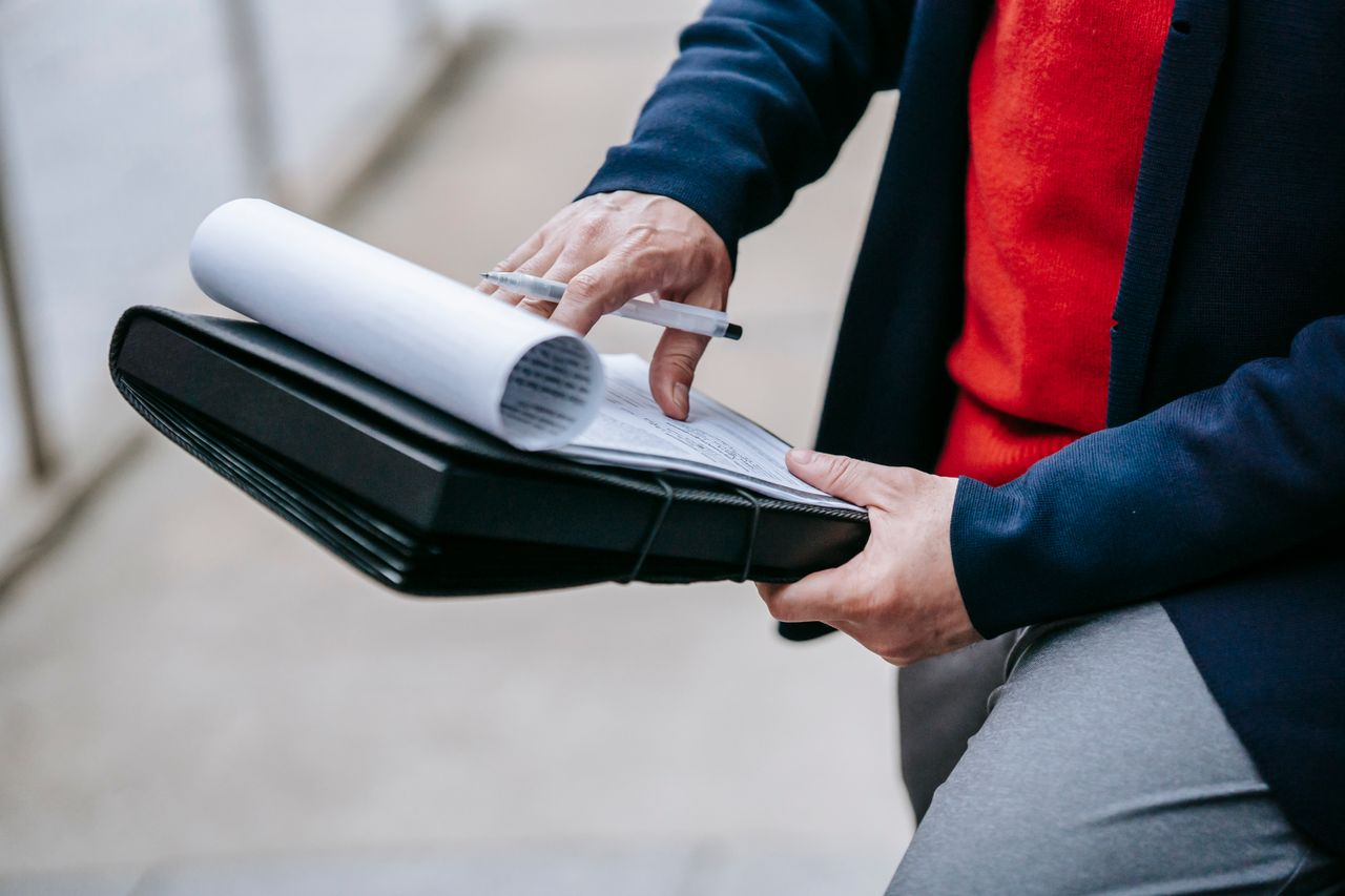 Close-up of a professional person reviewing documents
