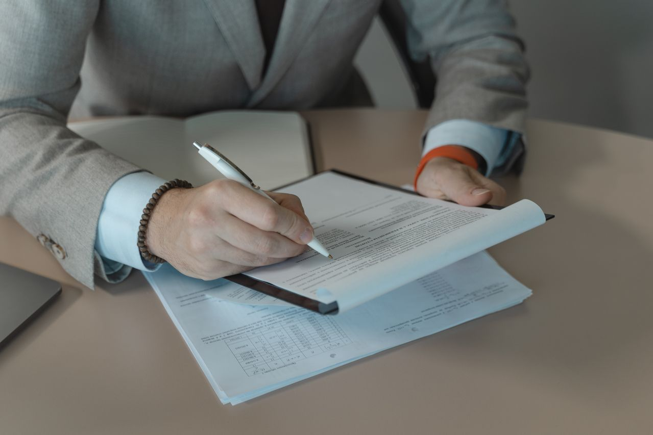 Close-up of business person signing documents
