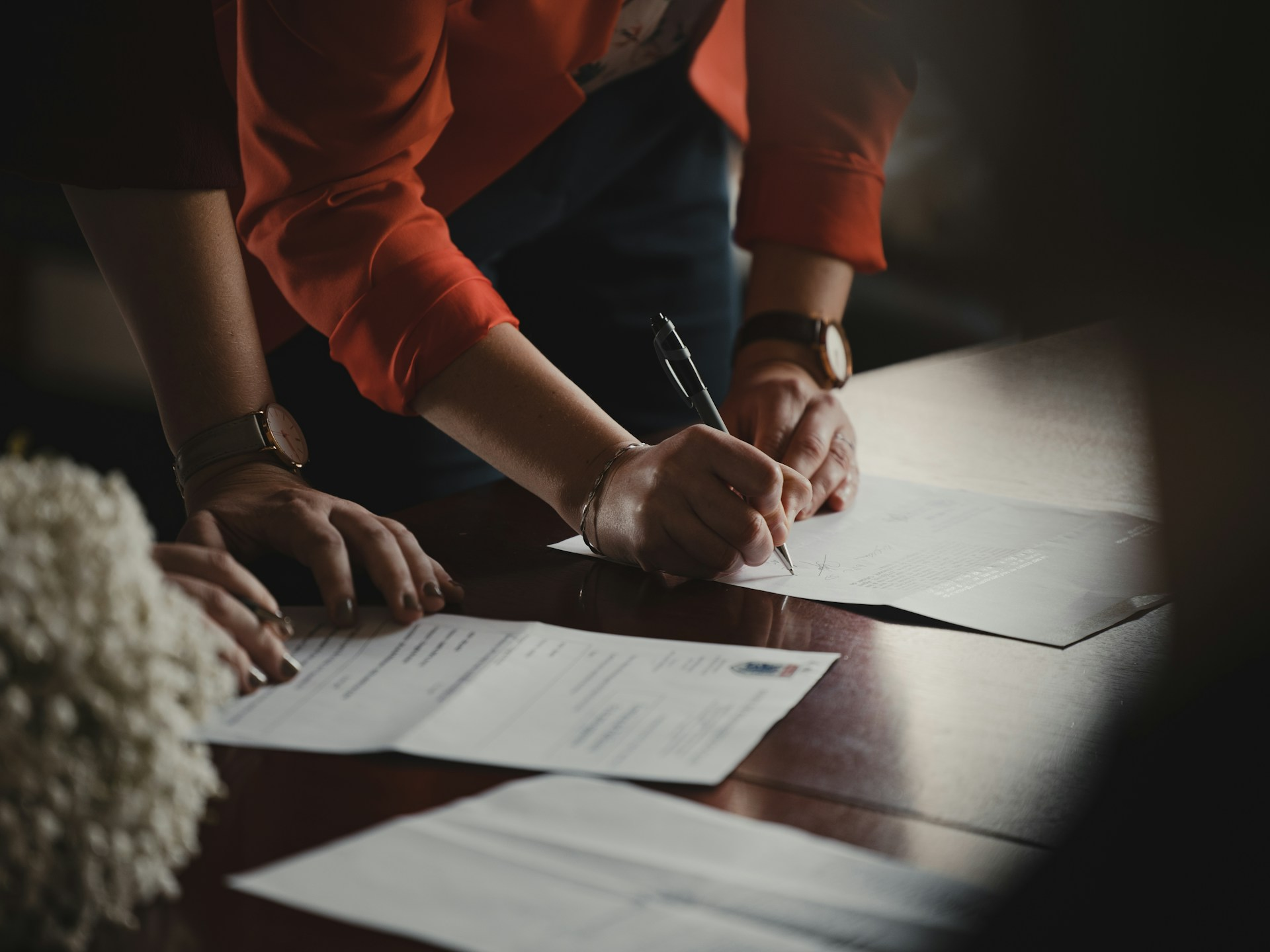 People signing business documents